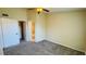 Bedroom featuring neutral walls, carpet, ceiling fan, and doors to the bathroom and closet at 1932 Lake Atriums Cir # 74, Orlando, FL 32839