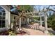 Charming patio area with decorative pergola and beautiful landscaping and flowering bushes at 1932 Lake Atriums Cir # 74, Orlando, FL 32839