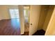 Hallway featuring wood floors and leads to the living area, providing a transition between spaces at 1932 Lake Atriums Cir # 74, Orlando, FL 32839