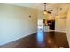 Inviting living room featuring sleek wood floors, a ceiling fan, and seamlessly connects to the kitchen area at 1932 Lake Atriums Cir # 74, Orlando, FL 32839