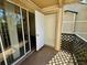 View of an open-air balcony with lattice railings and sliding glass doors at 1940 Lake Atriums Cir # 108, Orlando, FL 32839