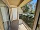 View from an open-air balcony with lattice railings and sliding glass doors at 1940 Lake Atriums Cir # 108, Orlando, FL 32839