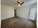 Bright bedroom with a ceiling fan, neutral walls, and a door leading to the outside at 1940 Lake Atriums Cir # 108, Orlando, FL 32839