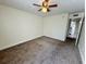 Well-lit bedroom featuring neutral walls, carpet flooring and a modern ceiling fan at 1940 Lake Atriums Cir # 108, Orlando, FL 32839