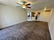 Open-concept living area with a ceiling fan and views into the kitchen at 1940 Lake Atriums Cir # 108, Orlando, FL 32839