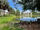 Scenic view of the community pond surrounded by lush landscaping and multi-story residential buildings at 1940 Lake Atriums Cir # 108, Orlando, FL 32839