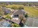 Aerial view of home showcases backyard with patio, tennis court, pool and well-maintained surrounding landscape at 1946 Thoroughbred Dr, Gotha, FL 34734