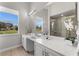 Bright bathroom features a large vanity, a garden view window, and tiled shower at 1946 Thoroughbred Dr, Gotha, FL 34734