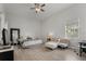 Large bedroom featuring hardwood floors, a ceiling fan, and natural light for a serene atmosphere at 1946 Thoroughbred Dr, Gotha, FL 34734