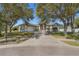 Traditional home with large trees shading the front lawn and driveway leading to a two-car garage at 1946 Thoroughbred Dr, Gotha, FL 34734