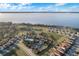 Aerial view featuring community pool, tennis court, neighborhood and lake at 1990 Appalachee Cir, Tavares, FL 32778