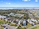 Panoramic aerial view of the neighborhood with lake views and various home styles at 1990 Appalachee Cir, Tavares, FL 32778