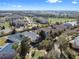 Scenic aerial view of the residential neighborhood with manicured lawns and green spaces at 1990 Appalachee Cir, Tavares, FL 32778