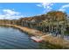 Waterfront aerial view featuring a dock and trees at 1990 Appalachee Cir, Tavares, FL 32778