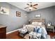 Comfortable bedroom featuring hardwood floors, and natural light from the window at 1990 Appalachee Cir, Tavares, FL 32778