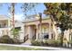 Inviting home exterior featuring a front porch with black metal railing and professional landscaping at 1990 Appalachee Cir, Tavares, FL 32778