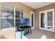 Outdoor patio area featuring a television, tiled floor and view to the backyard at 1990 Appalachee Cir, Tavares, FL 32778