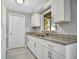 Bright kitchen featuring white cabinets, granite countertops, and stainless steel sink at 210 Cadillac Ct, Altamonte Springs, FL 32701