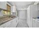 Open kitchen featuring white cabinetry, granite counters, and modern appliances at 210 Cadillac Ct, Altamonte Springs, FL 32701