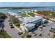 Aerial view featuring condo buildings, boat docks and community pool near waterfront at 2100 N Peninsula Ave # 1020, New Smyrna Beach, FL 32169