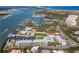 Aerial shot of a condominium community with a marina, water views, pool, and tennis courts at 2100 N Peninsula Ave # 1020, New Smyrna Beach, FL 32169