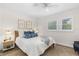 Cozy bedroom featuring a full bed with stylish blue accents and natural light from a window at 2100 N Peninsula Ave # 1020, New Smyrna Beach, FL 32169