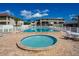 Community pool and hot tub surrounded by tables and chairs perfect for entertaining at 2100 N Peninsula Ave # 1020, New Smyrna Beach, FL 32169