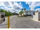 Exterior shot of the entrance to the property with palm trees and a well-maintained landscape at 2100 N Peninsula Ave # 1020, New Smyrna Beach, FL 32169