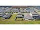 Aerial view of the backyard, featuring a screened lanai and well-manicured lawn in a residential neighborhood at 2687 Chantilly Ave, Kissimmee, FL 34741