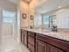 Bathroom with granite countertop, dark wood vanity, and large mirror at 2687 Chantilly Ave, Kissimmee, FL 34741