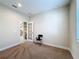 Neutral bedroom with a large window, beige carpeting, and door to a closet at 2687 Chantilly Ave, Kissimmee, FL 34741