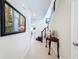 Hallway featuring stairs to second floor and neutral tile flooring leading to other living spaces at 2687 Chantilly Ave, Kissimmee, FL 34741