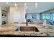 Kitchen island features stainless steel sink and granite countertop, opening to the living room at 2687 Chantilly Ave, Kissimmee, FL 34741