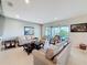 Spacious living room featuring neutral tones, tile flooring, and sliding glass doors to the lanai at 2687 Chantilly Ave, Kissimmee, FL 34741