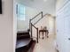 Staircase with wood steps, white railings, and a decorative table in the entry at 2687 Chantilly Ave, Kissimmee, FL 34741