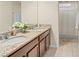 Bathroom featuring double sinks with granite countertops and tiled flooring near a shower area at 2926 Falconhill Dr, Apopka, FL 32712