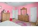 Pink bedroom with classic furniture, plush rug, teddy bears, and connecting doors to other rooms at 2926 Falconhill Dr, Apopka, FL 32712