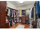 Spacious walk-in closet with custom shelves and hardwood floors at 2926 Falconhill Dr, Apopka, FL 32712