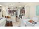 Modern kitchen and dining area featuring stainless steel appliances and dark wood cabinetry at 2926 Falconhill Dr, Apopka, FL 32712