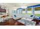 Living room featuring a white sofa, hardwood floors, and large windows at 2926 Falconhill Dr, Apopka, FL 32712