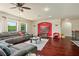 Comfortable living room with a red accent wall and a large sectional sofa, perfect for relaxing at 2926 Falconhill Dr, Apopka, FL 32712