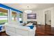 Bright living room with a plush white sectional sofa and a decorative modern light fixture at 2926 Falconhill Dr, Apopka, FL 32712