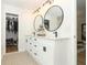 Modern bathroom featuring dual vanities, black fixtures, and a walk-in closet at 297 N Lake Jessup Ave, Oviedo, FL 32765