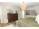 Cozy bedroom with an elegant chandelier, dark dresser, and stylish decorative accents at 297 N Lake Jessup Ave, Oviedo, FL 32765