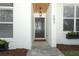 Inviting front entrance with stone pathway, brick facade, and decorative flower boxes at 297 N Lake Jessup Ave, Oviedo, FL 32765