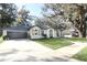 Beautiful white brick house with a well-manicured lawn and spacious driveway at 297 N Lake Jessup Ave, Oviedo, FL 32765