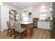 Bright kitchen featuring a large island, stainless steel appliances, and white cabinetry at 297 N Lake Jessup Ave, Oviedo, FL 32765