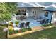 Aerial view of the backyard patio with lounge chairs and an outdoor seating arrangement surrounded by mature trees at 297 N Lake Jessup Ave, Oviedo, FL 32765