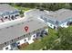 An aerial view of townhomes with screened patios, landscaping, and a parking area at 3031 Pilot House Pl, Oviedo, FL 32765