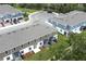 An aerial view of townhomes with screened patios, landscaping, and a parking area at 3031 Pilot House Pl, Oviedo, FL 32765